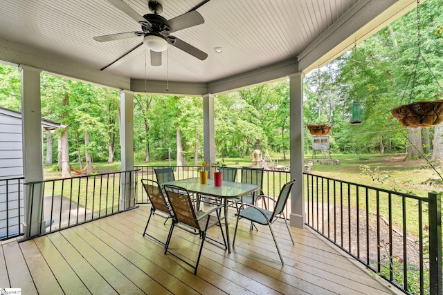 700 Old Green Pond Rd, Anderson, SC 29625 - wooden terrace with ceiling fan, outdoor dining space, a lawn, and view of wooded area