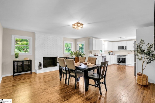 203 Homestead Dr, Taylors, SC 29687 - dining area featuring plenty of natural light, light wood finished floors, a fireplace, and baseboards