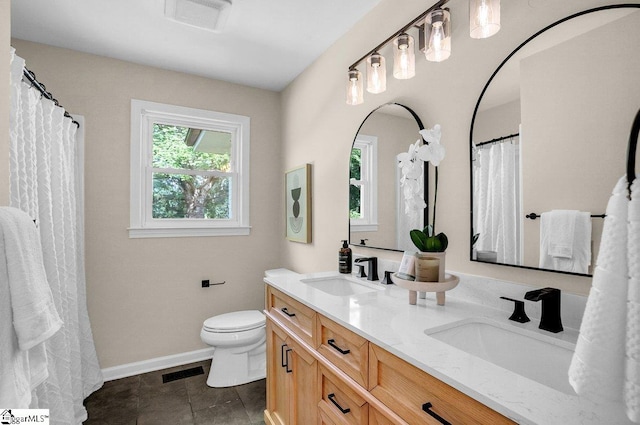 203 Homestead Dr, Taylors, SC 29687 - bathroom with toilet, double vanity, and baseboards