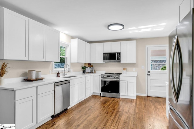 203 Homestead Dr, Taylors, SC 29687 - kitchen featuring appliances with stainless steel finishes, a sink, white cabinetry, light countertops, and dark wood-type flooring