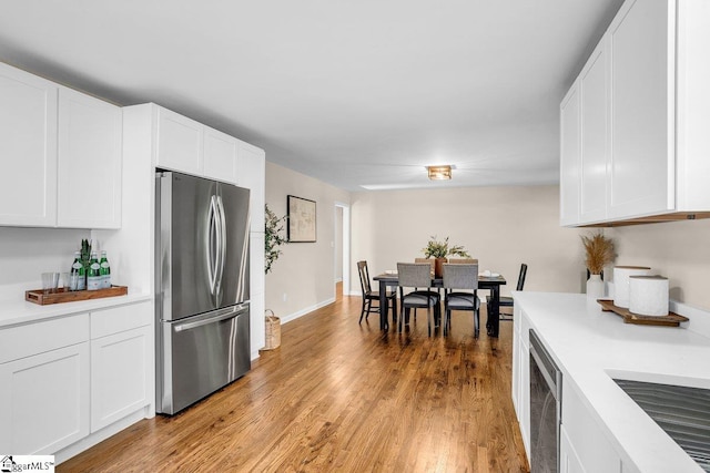 203 Homestead Dr, Taylors, SC 29687 - kitchen with freestanding refrigerator, light countertops, white cabinetry, and light wood-style flooring