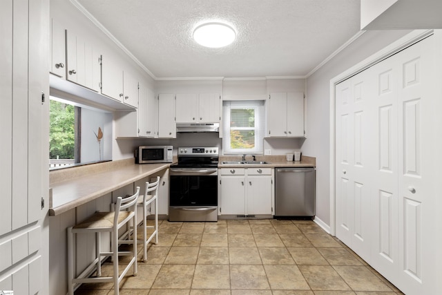 65 Westview Ave, Greenville, SC 29607 - kitchen with appliances with stainless steel finishes, a sink, a textured ceiling, ornamental molding, and light countertops