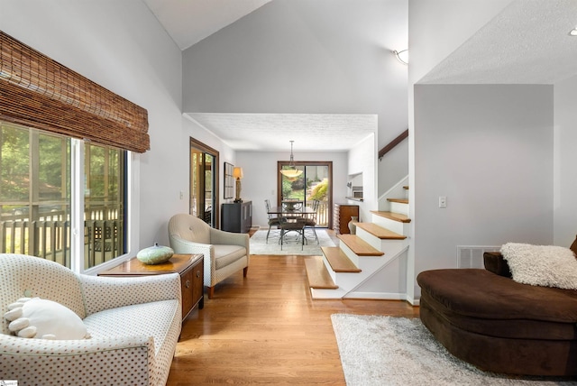 65 Westview Ave, Greenville, SC 29607 - living area featuring stairway, high vaulted ceiling, and wood finished floors
