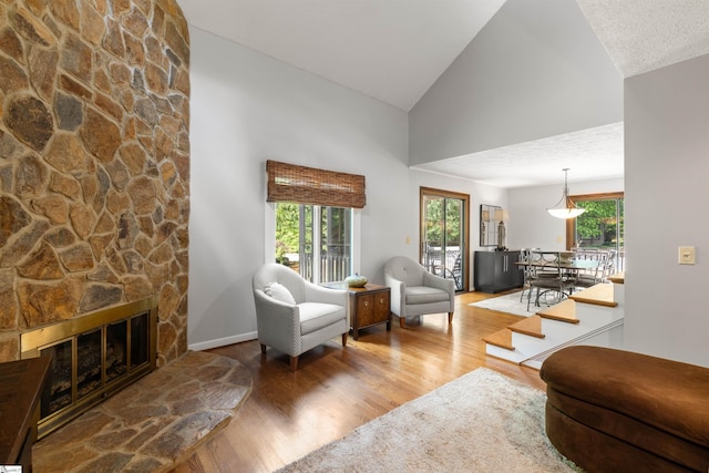 65 Westview Ave, Greenville, SC 29607 - living room with wood finished floors, high vaulted ceiling, a fireplace, and baseboards