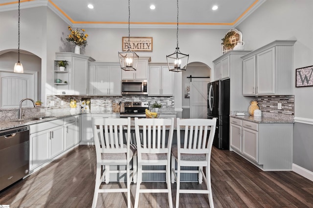 406 Jersey Queen Trl, Greer, SC 29651 - kitchen with appliances with stainless steel finishes, arched walkways, backsplash, open shelves, and recessed lighting