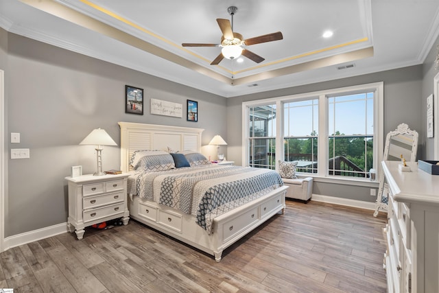 406 Jersey Queen Trl, Greer, SC 29651 - bedroom with a raised ceiling, baseboards, ornamental molding, wood finished floors, and recessed lighting