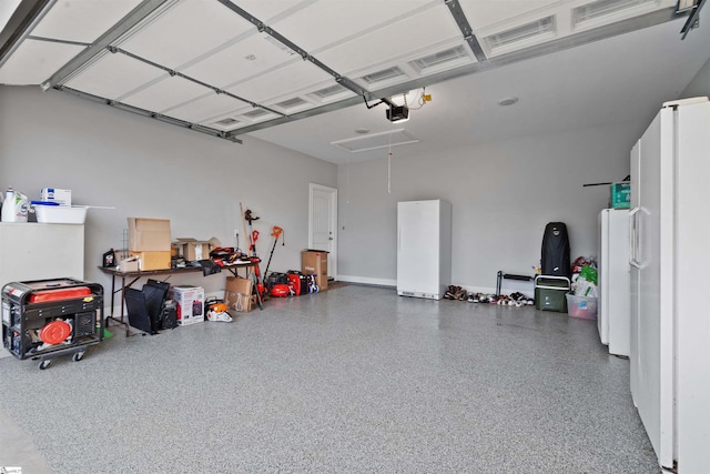 406 Jersey Queen Trl, Greer, SC 29651 - garage featuring freestanding refrigerator and a garage door opener