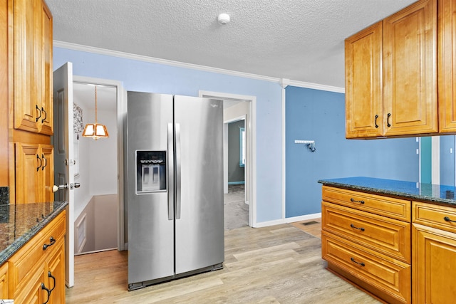 12 Fowler Cir, Greenville, SC 29607 - kitchen with stainless steel fridge with ice dispenser, light wood-style flooring, ornamental molding, brown cabinets, and dark stone counters