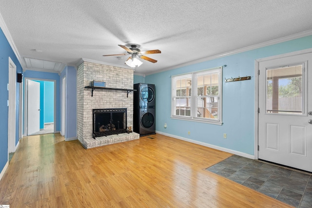 12 Fowler Cir, Greenville, SC 29607 - unfurnished living room featuring stacked washing machine and dryer, attic access, a ceiling fan, crown molding, and healthy amount of natural light