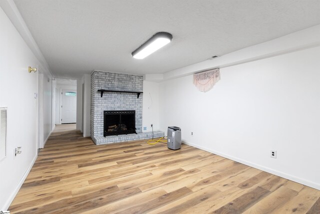 12 Fowler Cir, Greenville, SC 29607 - unfurnished living room with a fireplace, light wood-type flooring, baseboards, and a textured ceiling