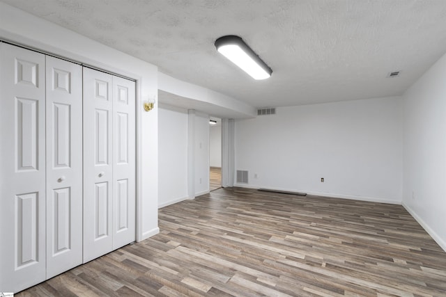 12 Fowler Cir, Greenville, SC 29607 - unfurnished bedroom featuring wood finished floors, baseboards, a textured ceiling, and a closet