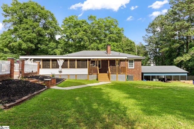12 Fowler Cir, Greenville, SC 29607 - rear view of house featuring a chimney, a sunroom, a yard, brick siding, and metal roof