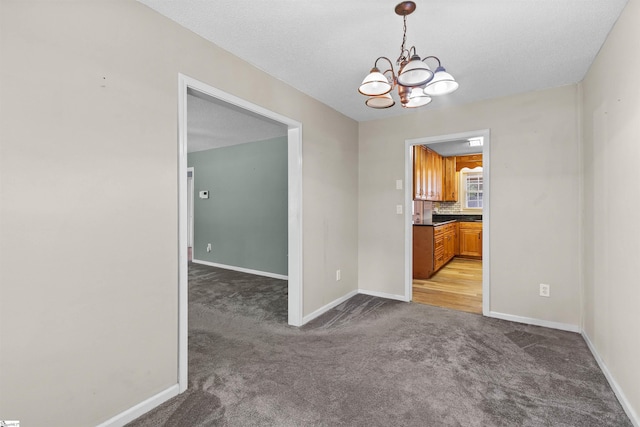 12 Fowler Cir, Greenville, SC 29607 - empty room featuring light carpet, a chandelier, and baseboards