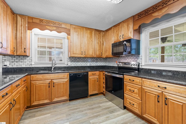 12 Fowler Cir, Greenville, SC 29607 - kitchen featuring black appliances, a sink, light wood-type flooring, tasteful backsplash, and brown cabinets
