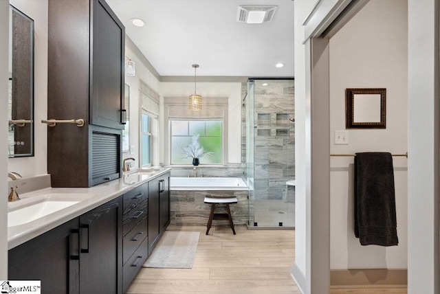 5 Maxfli Ct, Greenville, SC 29690 - full bath with wood finished floors, a stall shower, a bath, double vanity, and recessed lighting
