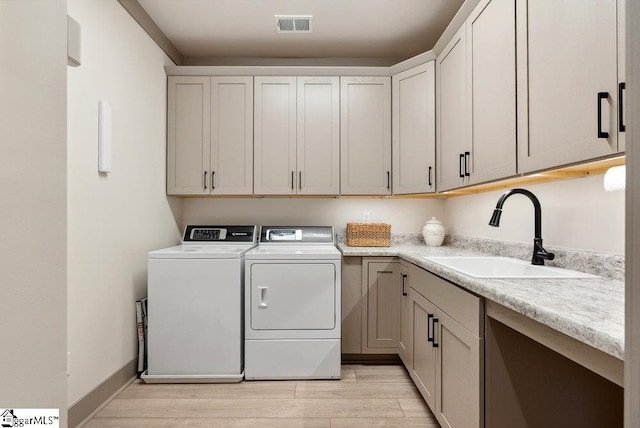 5 Maxfli Ct, Greenville, SC 29690 - laundry area featuring washer and clothes dryer, cabinet space, and light wood finished floors