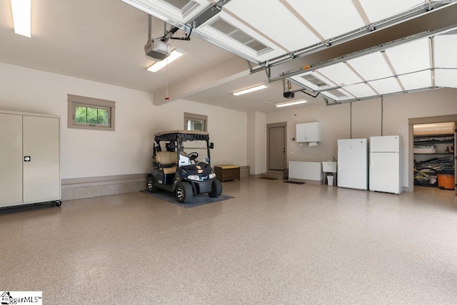 5 Maxfli Ct, Greenville, SC 29690 - garage with freestanding refrigerator, a garage door opener, and a sink
