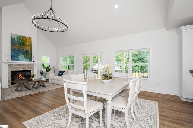 710 N Main St, Greer, SC 29651 - dining space with high vaulted ceiling, a glass covered fireplace, baseboards, dark wood finished floors, and a chandelier