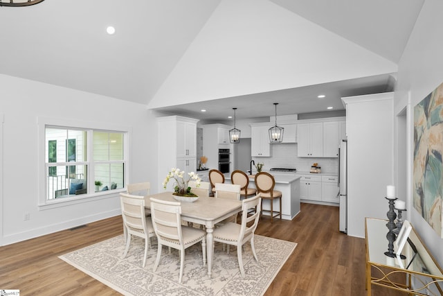 710 N Main St, Greer, SC 29651 - dining space featuring high vaulted ceiling, dark wood-style flooring, recessed lighting, and baseboards