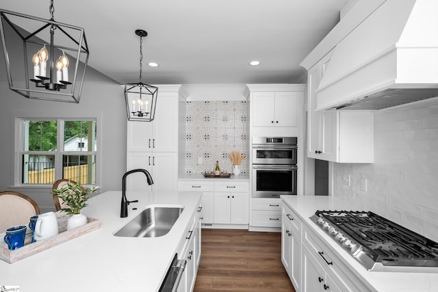 710 N Main St, Greer, SC 29651 - kitchen with a sink, appliances with stainless steel finishes, premium range hood, a chandelier, and tasteful backsplash