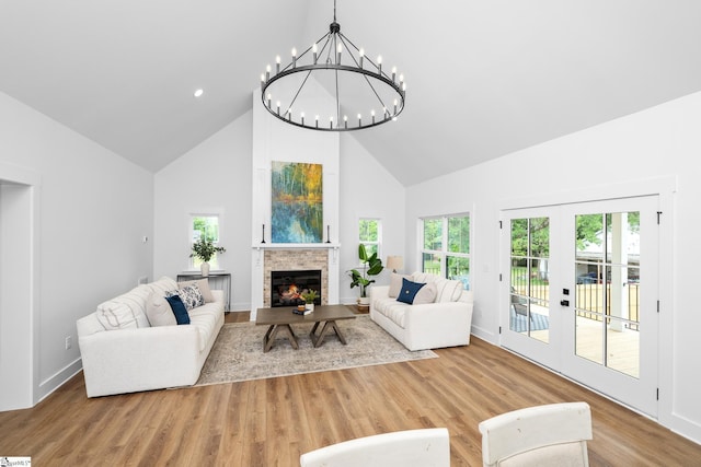 710 N Main St, Greer, SC 29651 - living area featuring high vaulted ceiling, a glass covered fireplace, a chandelier, wood finished floors, and baseboards