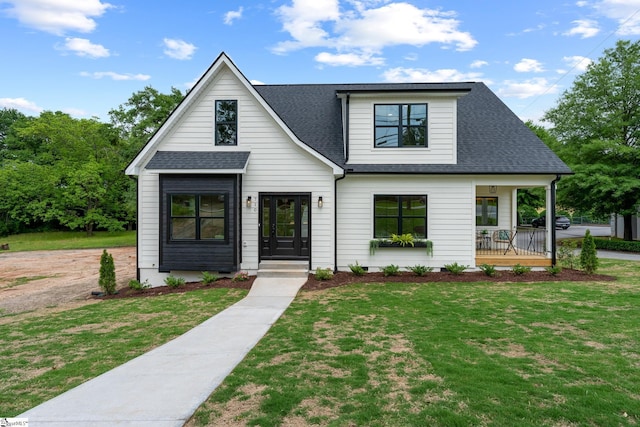 710 N Main St, Greer, SC 29651 - modern inspired farmhouse with roof with shingles, a front yard, and covered porch
