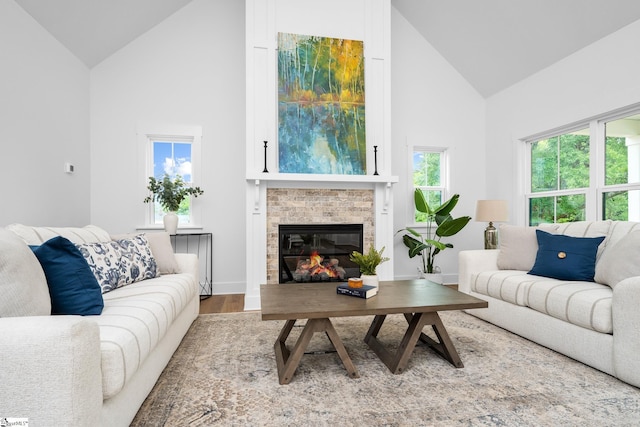 710 N Main St, Greer, SC 29651 - living area with high vaulted ceiling, wood finished floors, a brick fireplace, and baseboards