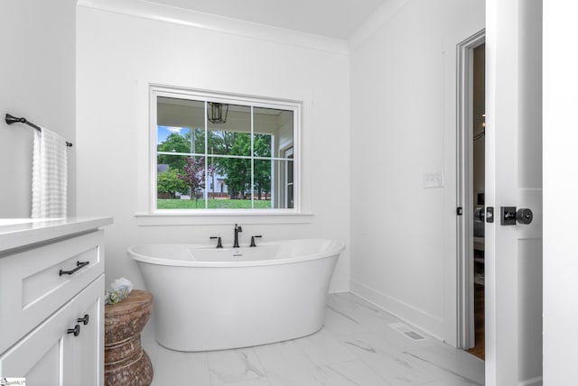 710 N Main St, Greer, SC 29651 - bathroom featuring marble look tile flooring, a soaking tub, vanity, and baseboards