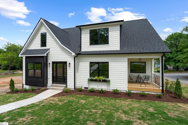 710 N Main St, Greer, SC 29651 - modern farmhouse style home featuring covered porch, a shingled roof, and a front yard