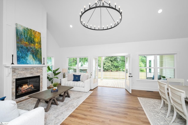 710 N Main St, Greer, SC 29651 - living area with plenty of natural light, high vaulted ceiling, a chandelier, light wood finished floors, and a brick fireplace