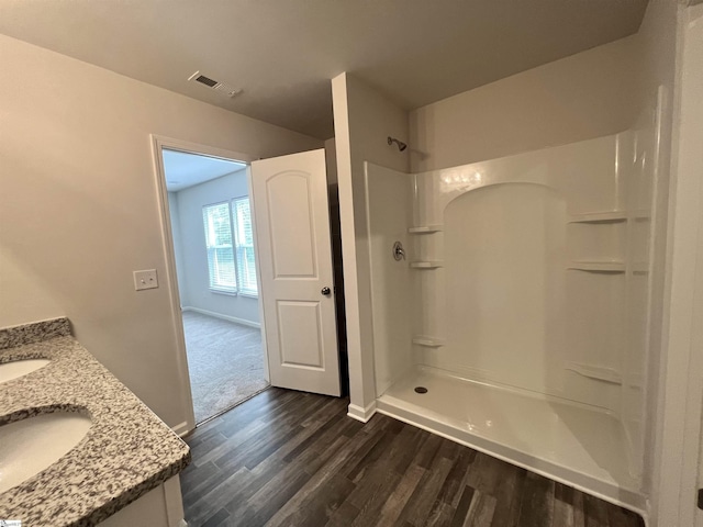 618 Farmstead Trl, Inman, SC 29349 - bathroom with wood finished floors, a shower, vanity, and baseboards