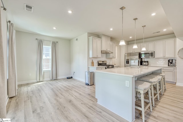 1128 Grovewood Ct, Moore, SC 29369 - kitchen with appliances with stainless steel finishes, light wood finished floors, backsplash, light countertops, and recessed lighting