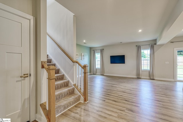 1128 Grovewood Ct, Moore, SC 29369 - unfurnished living room featuring plenty of natural light, light wood-style flooring, stairway, recessed lighting, and baseboards