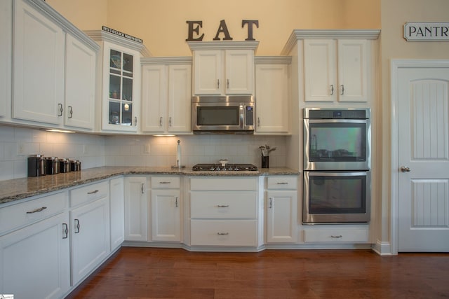 250 Chickadee Trl, Easley, SC 29642 - kitchen featuring stainless steel appliances, backsplash, glass insert cabinets, light stone countertops, and white cabinetry
