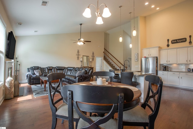 250 Chickadee Trl, Easley, SC 29642 - dining room with high vaulted ceiling, dark wood-style floors, a ceiling fan, stairway, and a chandelier