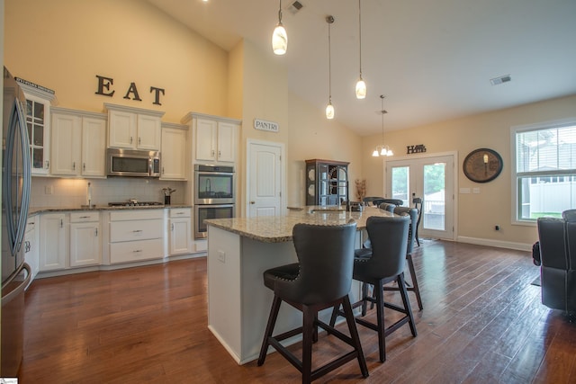 250 Chickadee Trl, Easley, SC 29642 - kitchen featuring stainless steel appliances, high vaulted ceiling, french doors, light stone countertops, and backsplash