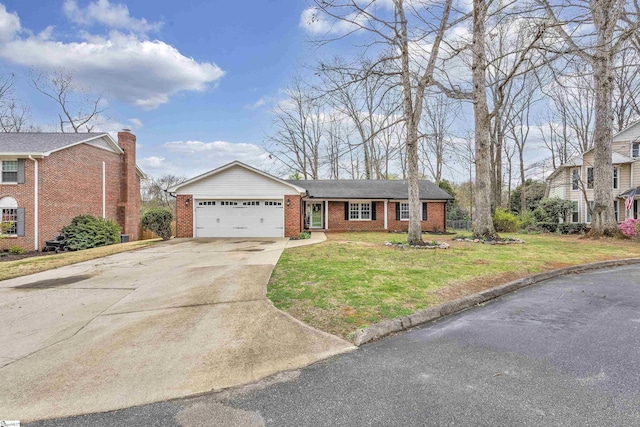view of front of house with brick siding, a garage, driveway, and a front lawn