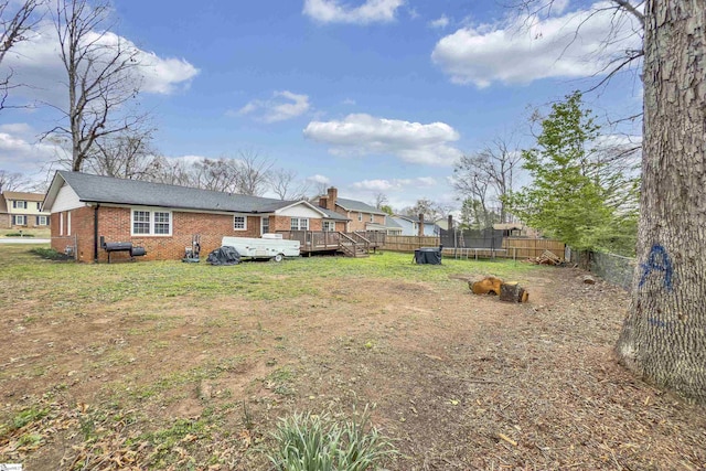view of yard featuring a trampoline and a deck