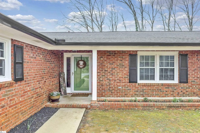 doorway to property with brick siding