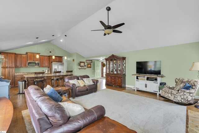 living room featuring wood finished floors, ceiling fan, and high vaulted ceiling