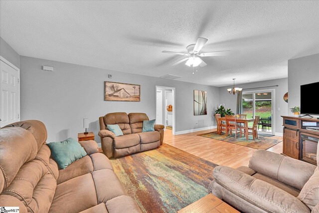 205 Willow Leaf Dr, Seneca, SC 29672 - living area with light wood-type flooring, a ceiling fan, a textured ceiling, baseboards, and a chandelier