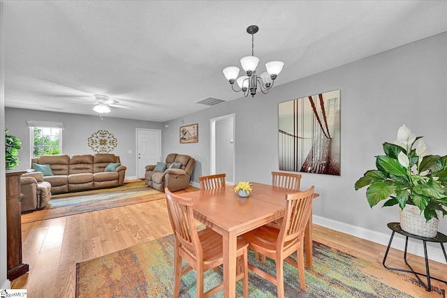 205 Willow Leaf Dr, Seneca, SC 29672 - dining area with wood finished floors, a chandelier, baseboards, a ceiling fan, and a textured ceiling