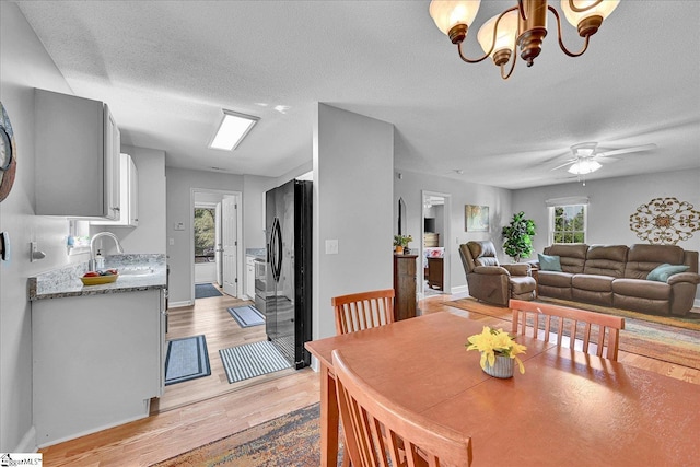 205 Willow Leaf Dr, Seneca, SC 29672 - dining space featuring light wood finished floors, a textured ceiling, ceiling fan, baseboards, and a chandelier