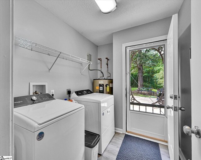 205 Willow Leaf Dr, Seneca, SC 29672 - laundry area with water heater, washing machine and dryer, light wood finished floors, a textured ceiling, and baseboards