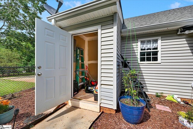 205 Willow Leaf Dr, Seneca, SC 29672 - view of exterior entry with fence and roof with shingles