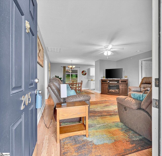 205 Willow Leaf Dr, Seneca, SC 29672 - living room with light wood-style floors, ceiling fan, a chandelier, and baseboards
