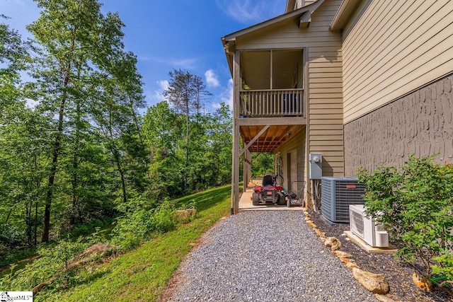 415 W V Thompson Rd, Rutherfordton, NC 28139 - view of side of property featuring cooling unit, a patio, ac unit, and gravel driveway