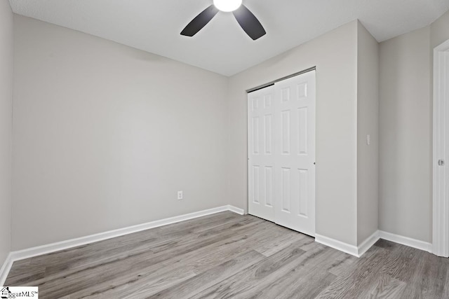 338 E Celestial Dr, Greer, SC 29651 - unfurnished bedroom with wood finished floors, baseboards, a closet, and a ceiling fan