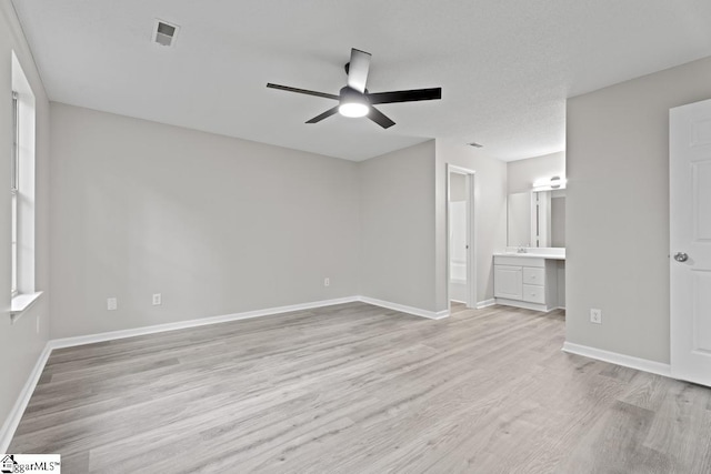 338 E Celestial Dr, Greer, SC 29651 - unfurnished bedroom with light wood-style flooring, baseboards, connected bathroom, and ceiling fan