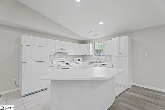 338 E Celestial Dr, Greer, SC 29651 - kitchen featuring white appliances, under cabinet range hood, vaulted ceiling, white cabinetry, and a sink